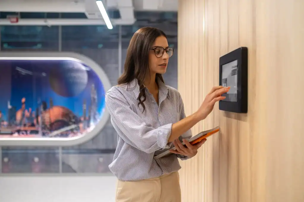 Security Access Control Systems In Dubai​ - women Touching Control Panel